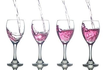 Filling red wine in glasses isolated on white background