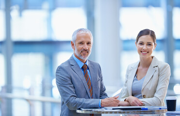 Old talent, new talent. Portrait of a mature businessman standing with a younger female colleague.