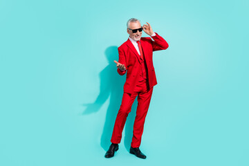 Photo of funky retired man wear red suit dark eyewear inviting you dance isolated turquoise color...