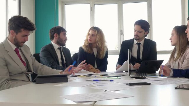 business meeting -young manager explains to his collaborators the new assignment