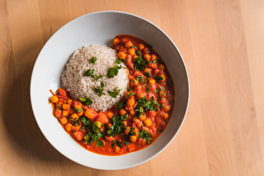 curry vegetarian chickpeas with vegetables. close up of fresh vegan indian curry, traditional meal of indian cuisine with coriander and basmati rice top view