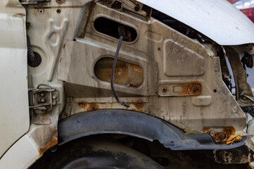 a car with the front fender removed