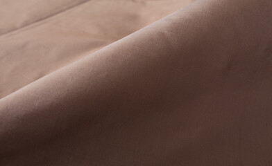 Close up of texture of hand woven Thai silk in earth tone colour