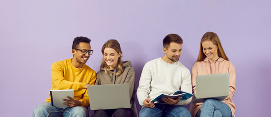 Student friends prepare for the lecture together with the help of gadgets and notebooks....