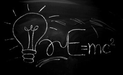 Board with chalk. The equation for the energy of light is written on the blackboard with chalk. Geometry and trigonometry. School