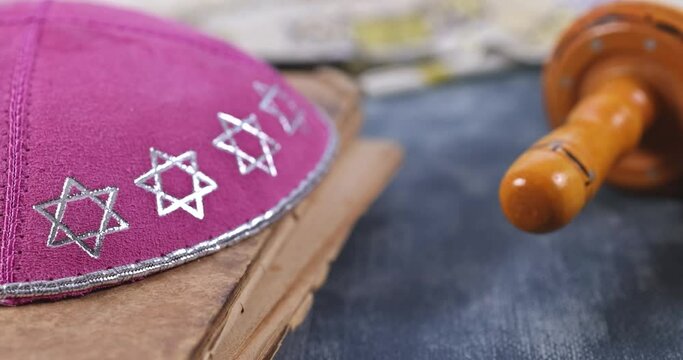 Jewish holidays in a synagogue prayer items with prayer shawl tallit shofar horn , torah scroll on soft focus