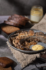 Selective focus baked lamprey in black tea jelly with mustard traditional Latvian cousins  
