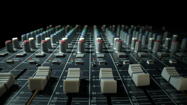 4K: Audio Mixer or Sound Desk with close up of the faders, channels and knobs. Sound board. Tracking Shot. Stock video clip footage