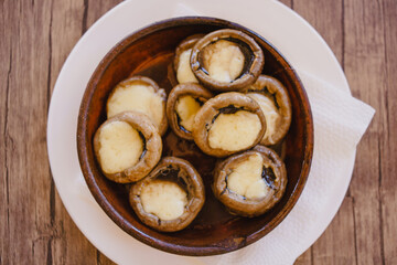 Mushrooms baked with cheese and cream in the national ceramic ketsi plate