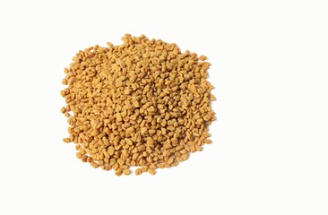 Closeup of Fenugreek or Methi Seeds Isolated on White Background With Copy Space