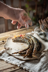 Lamprey baked on grill with black tea in rustic kitchen interior traditional Latvian food