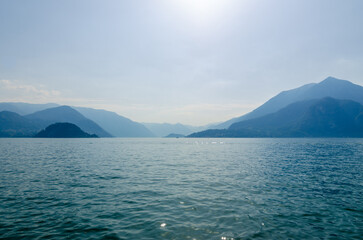 Landscape with sea and hills or mountains, the mist reverberates the blue effect of the sea and sky.
