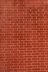 Fototapeta na wymiar Brick wall is bright red, texture of stone blocks, background of bricks.