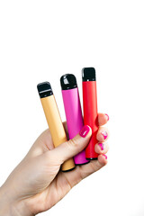 Set of disposable electronic cigarette in hand close-up on a white background. The concept of modern smoking, vaping and nicotine. Copy space