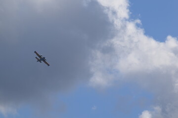 Airplane silhouette on the background of the sky with clouds
