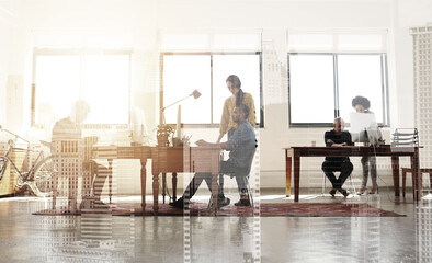 Designers doing what they do best. Multiple exposure shot of colleagues working in a modern office superimposed over a city background.