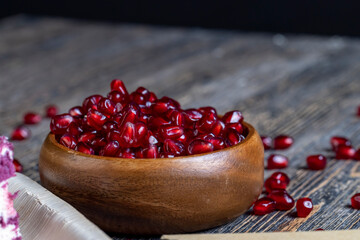 scattered pomegranate seeds on a wooden board