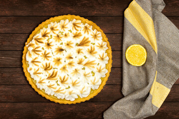 homemade lemon meringue pie with lemon fruit on wooden background