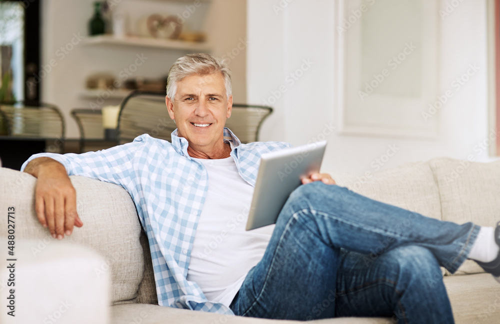 Aufkleber i always liked keeping up with the latest news.... shot of a mature man using his digital tablet whi