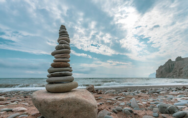Fototapeta na wymiar Pyramid of pebbles on the shore of the Black Sea