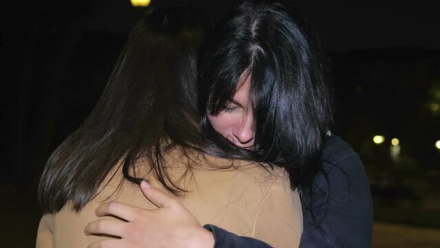 Girls first embrace and then discuss