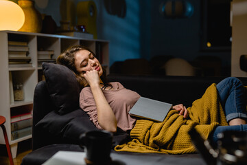 Obraz na płótnie Canvas woman fell asleep while reading book at home