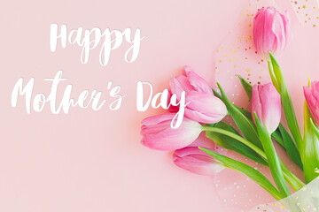 Happy mothers day text on pink tulips bouquet on pink background. Stylish greeting card. Happy Mother's Day, gratitude and love to mom. Handwritten lettering