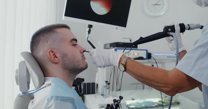 An ENT examines the patient's sinuses using a medical mini camera