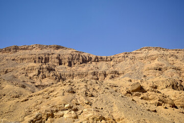 Fototapeta na wymiar Desert landscape in Egypt. View of sandy hill against clear sky. Selective focus.