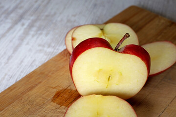 sliced apple on wooden board
