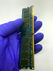 RAM memory kept in a gloved hand closeup view isolated on white background