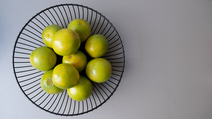 Orange basket over grey background.