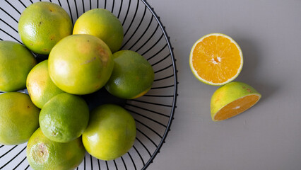 Orange basket over grey background.