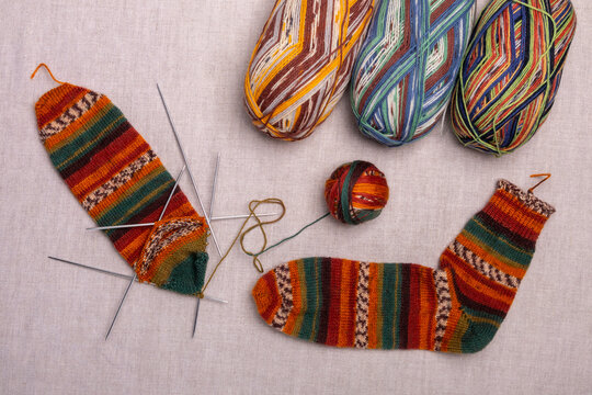 socks knitted from multicolored yarn - Powered by Adobe