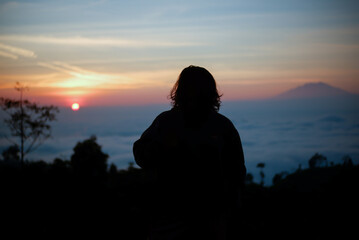 Fototapeta na wymiar silhouette on the mountain at sunrise