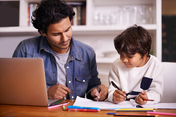 Careful guidance leads to even greater rewards. Shot of a father helping his son with his homework.