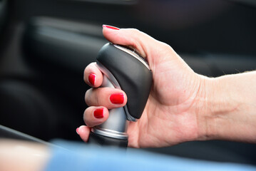 Woman shift gears in car  - 488046389