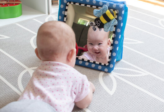 Baby looking in the mirror