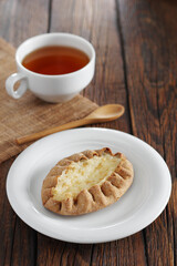 Bun with rice pudding and tea cup