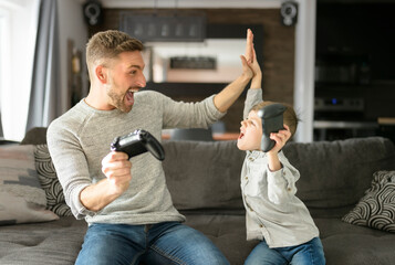 Father or Godfather having fun on the living room At Home play video game
