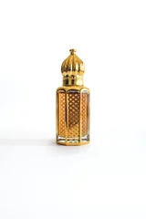 Fototapeten Arabian oud perfume in mini gold bottle. Isolated on white background. Copy space.  © Nicole Kandi
