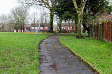 the walkway to the estate among grass and trees