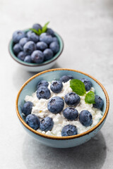 Cottage cheese with blueberry, fresh berries, keto healthy breakfast concept, top view.