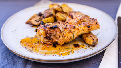 High view of some delicious baked chicken legs with rustic potatoes and some delicious boletus sauteed in EVOO and Spanish paprika.