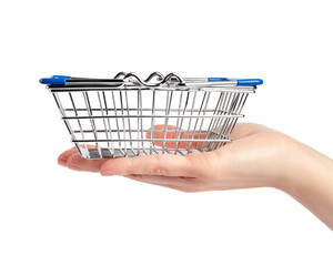 Small shopping basket on a woman's palm isolated on white background. Shopping concept. Copy space