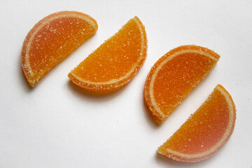 Dessert marmalade in the form of lemon and orange slices. The sweetness of jelly candy.