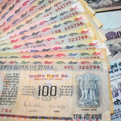 Old One Hundred Rupee notes combined on the table, India money on the rotating table. Old Indian Currency notes on a rotating table, Indian Currency on the table