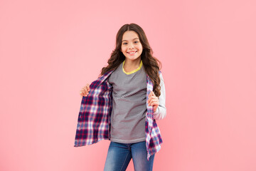 happy child in checkered shirt on pink background, childhood