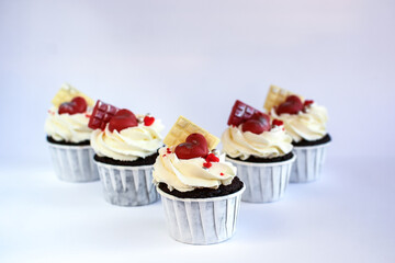 chocolate cupcakes with cream cheese frosting and festive decor. Valentine's day or birthday dessert. Beautiful festive food for a wedding or children's party.