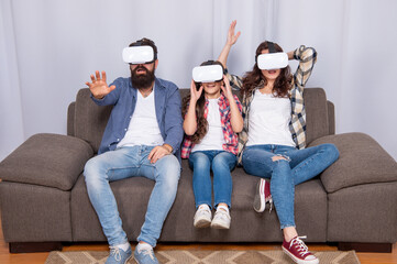modern life. father mother and child wireless VR glasses. virtual reality family